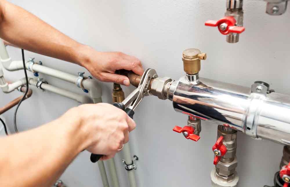 Hot Water System Technician Doing Water Heater System Repair